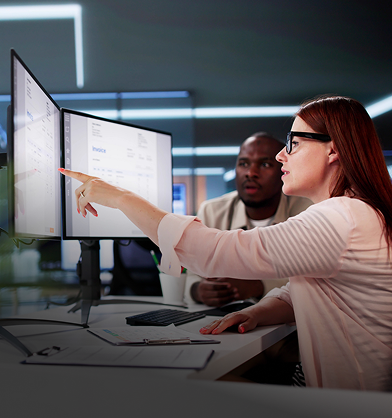 Two people working at computer screens.